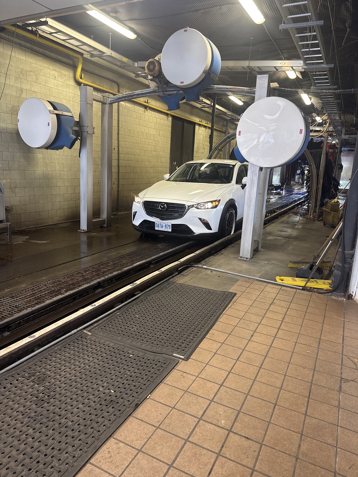 Vehicle entering the automatic wash conveyor tunnel