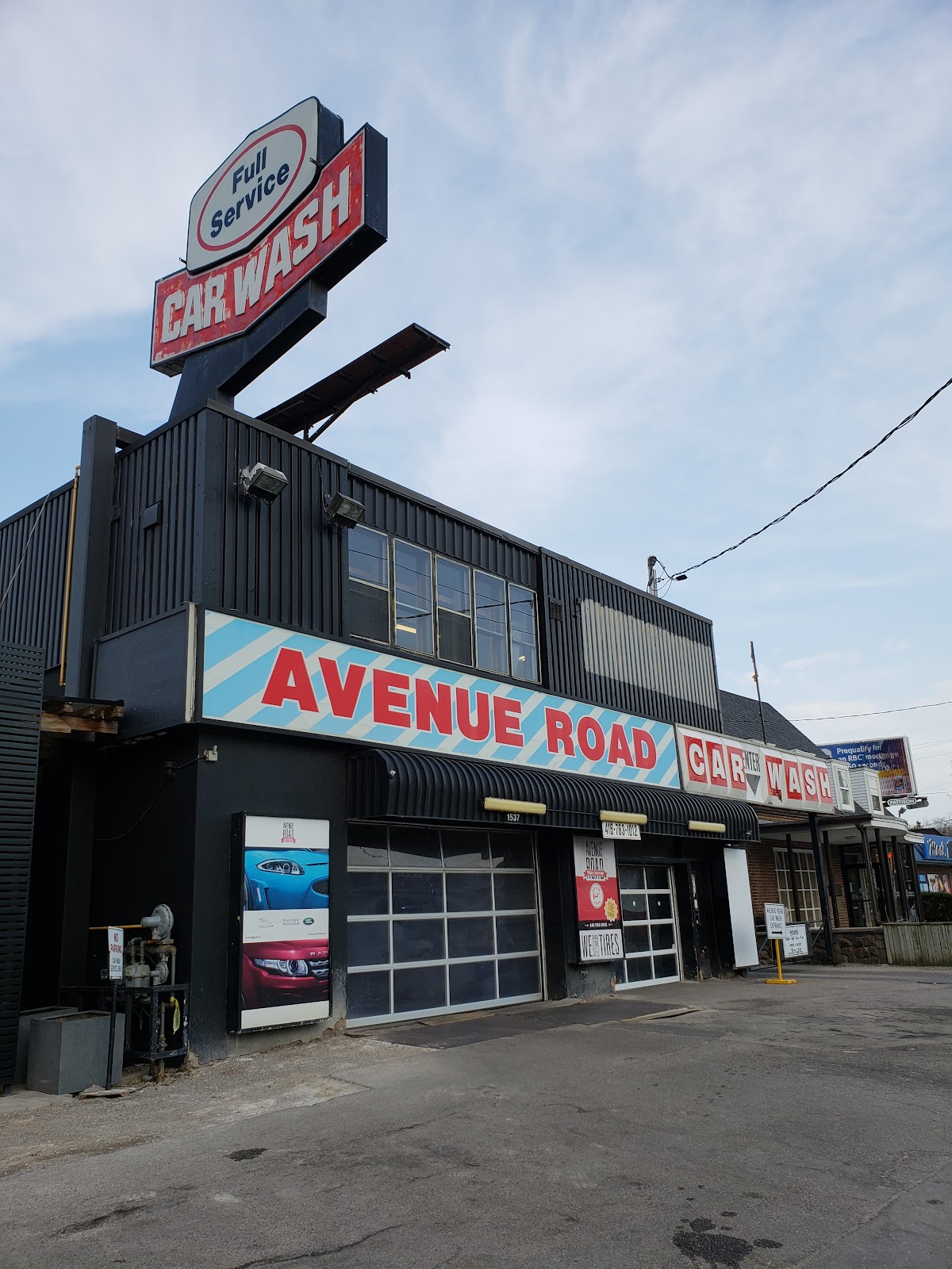 The car wash building from across the street showing the Full Service Car Wash sign