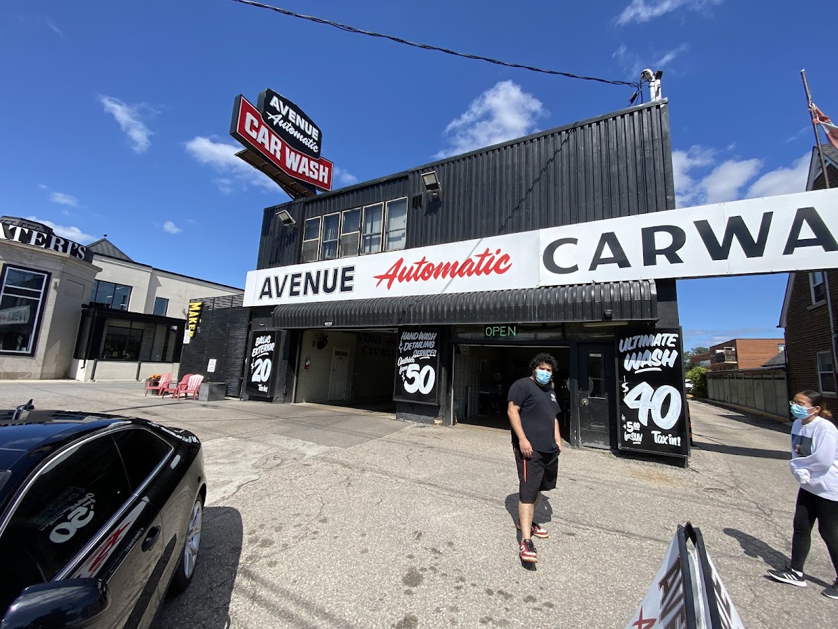 Avenue Automatic Car Wash building on a sunny day with staff working at the entrance